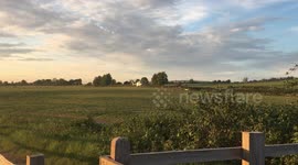 Helicopter / Air Ambulance takes off from field, flies overhead and then off into the sunset. Rural footage of Helicopter / Air Ambulance. South Downs