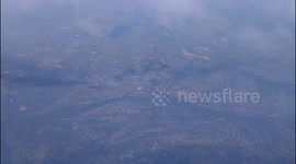 Plane Reflected with a Rainbow Halo over Clouds Below