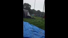 Disappointed festivalgoers shelter from the rain at V festival