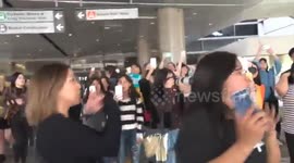 K-pop group NCT 127 surrounded by fans as they arrive at LAX, Los Angeles