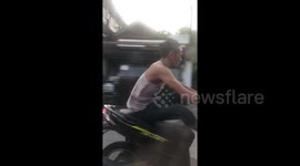 Thai motorcyclist arrested after standing on the seat while speeding down motorway