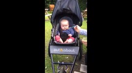 This six-month-old girl simply does not want to eat any mushy peas