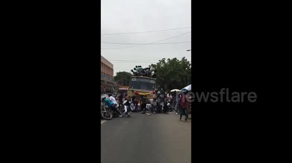 Terrifying moment celebrating students fall from top of moving bus in ...
