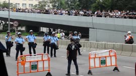 Hong Kong protester defiantly stands on his own in front of police