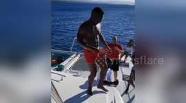 A man fails miserably attempting to jump off a yacht