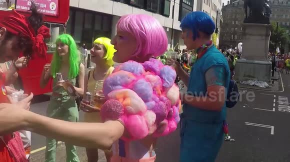 Group of friends in different colours standing around for Pride