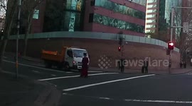 Man crossing road absolutely oblivious to traffic around him