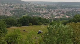 Police crime scene unit & drone operators searching over the cliff edge at High Tor, Giddy Edge, Matlock Bath, Matlock, Derbyshire, UK 27/06/2019