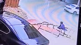 Flooded road under construction in China sees 2 scooter drivers fall into hole