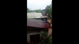 Muddy flood waters submerge houses after heavy rain in the Philippines
