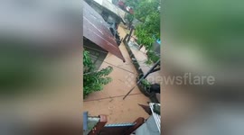 Muddy flood waters submerge houses after heavy rain in the Philippines