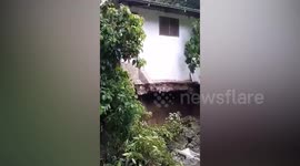 Monsoon landslides leave homes hanging dangerously over river in the Philippines