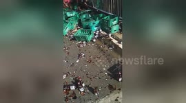 Locals scramble to collect beer bottles that fell from lorry on road in the Philippines