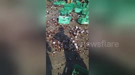 Locals scramble to collect beer bottles that fell off lorry on road in the Philippines