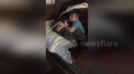 Heartwarming moment young boy comforts scared dog during fireworks