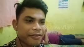 a man in the field falls asleep while listening. music on cellphones and still installed headsets