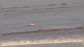 Daredevil men washed away by Qiantang River tide after trying to get back to shore