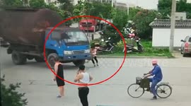 Chinese woman attempts to scam driver by lying in front of truck