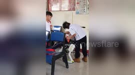 Newsflare Edit - Touching moment two schoolboys help their disabled classmate at break time