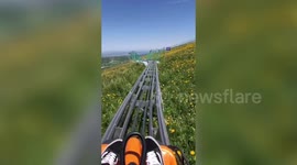 Tourists slide down mountain while enjoying the impressive landscape in China's Jiang Bulake