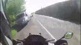 Dramatic footage shows motorcyclist dodge a head-on collision on UK road