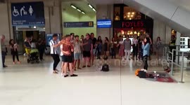 Busker In Waterloo Station Gets Group Of Guys Overwhelmed 
