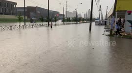 A man swims in a giant puddle in Krasnodar in southern Russia