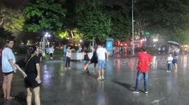 Although it was raining heavily, a group of young people still played jumping rope on the street in Viet Nam