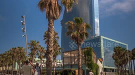 POV shot along the beach in barcelona towards the W hotel