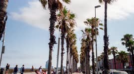 POV shot along the beach promenade in port olympic, barcelona
