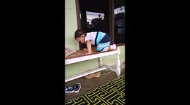 Little girl climbed onto the table fearlessly