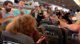 Passengers stranded on Heathrow flight dance to band during four hour wait