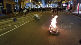 Protesters kept a fire burning on Des Voeux Road in an attempt to keep police from advancing