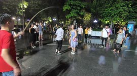 A great moment, a group of young people play jumping rope in a very heavy rain