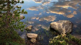 Beautiful could reflection time-lapse over lake