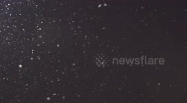 Pretty snowflakes falling at night in Markham Ontario Canada on cold January night to remind everyone around the world in this hot weather that there is still hope