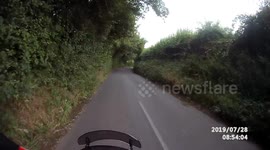 This dash cam video shows the shocking moment two motorcyclists swerved out of the way of a car driving on the WRONG side of the road