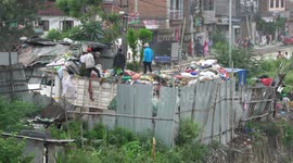 Sanitation workers picking through a mountain of trash to find recyclables in Kathmandu, Nepal