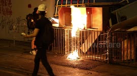 Protesters in Hong Kong light a fire at the gates of Shatin Police Station
