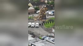 Youths climb atop Belfast 'anti-internment' bonfire prompting heavy police presence