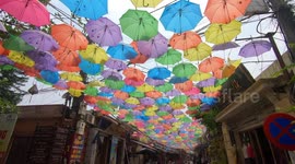 Unique street with thousands of colorful umbrellas hung in the sky in Vietnam