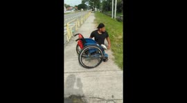Heartwarming moment disabled man climbs out of wheelchair to save kitten stuck in drain in Malaysia