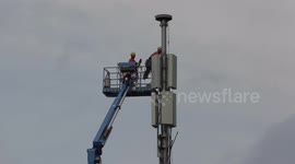 Technicians working on cellphone antenna tower as the work to launch 5G networks continues in North America