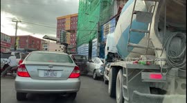 Cement mixer smashes into cars while trying to squeeze through narrow gap in Cambodia