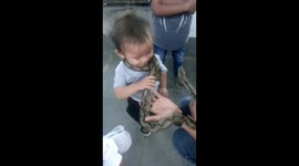 2-year-old excited to have LIVE PYTHON wrapped around him at pet expo