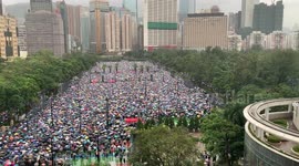 Hoards of protesters in Hong Kong march under umbrellas