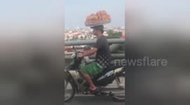 'Basket case biker' spotted on Vietnam highway with bread balancing on his head