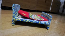 Hamster enjoys a nice lie in on his mini-sized bed