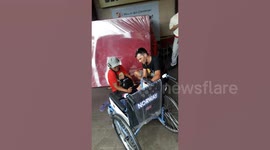 Heartwarming moment tourist gives brand new wheelchair to disabled man begging outside shops