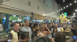 John Legend and Chrissy Teigen walk around Thai street food market